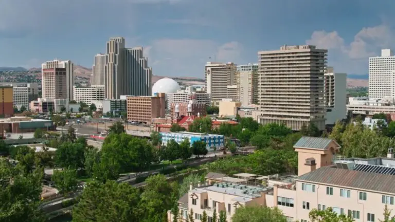 Downtown Reno skyline with high rise buildings and mountains in the background