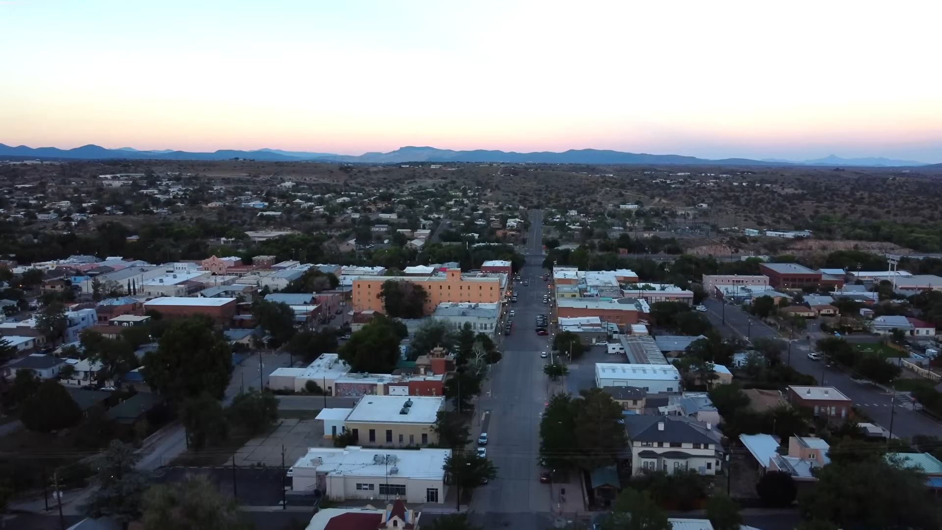 Aerial view of Silver City, New Mexico, with historic buildings and desert mountains in the distance.